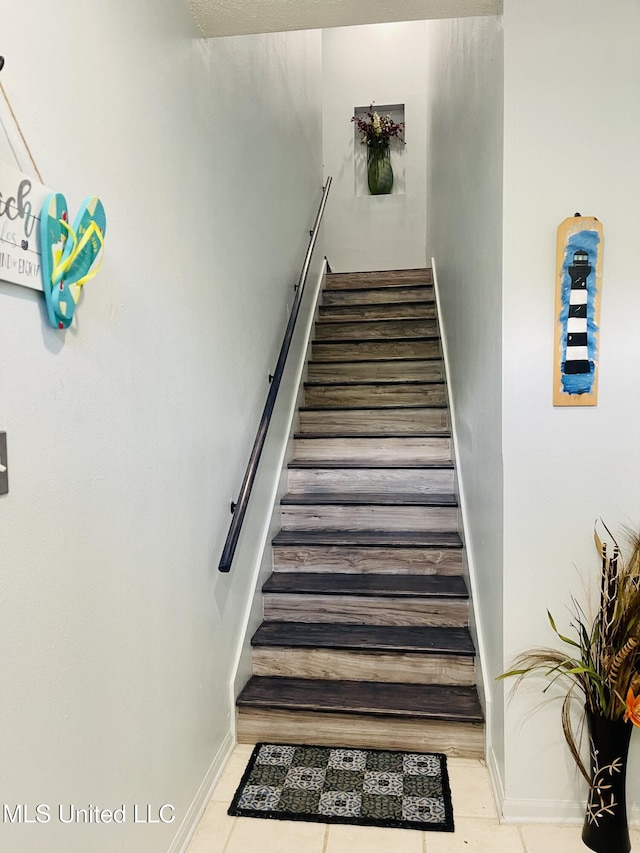 2252 Beach Dr Unit 305, Gulfport, MS 39507 - stairway featuring tile patterned flooring and baseboards