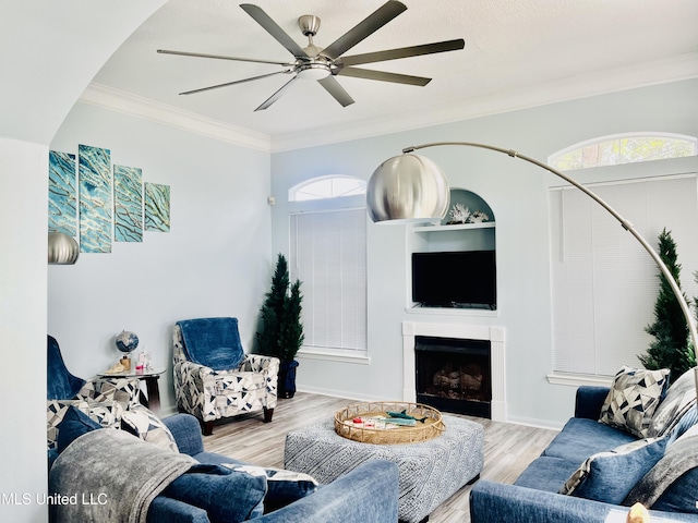 2252 Beach Dr Unit 305, Gulfport, MS 39507 - living area featuring ceiling fan, wood finished floors, ornamental molding, and a fireplace