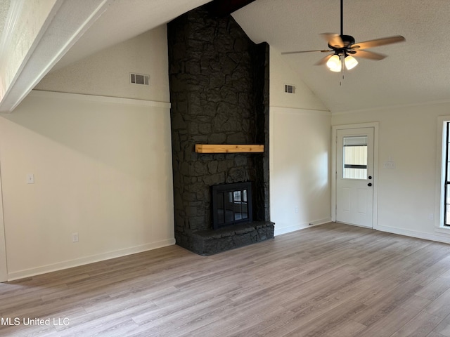 unfurnished living room with light hardwood / wood-style floors, a textured ceiling, a fireplace, and ceiling fan