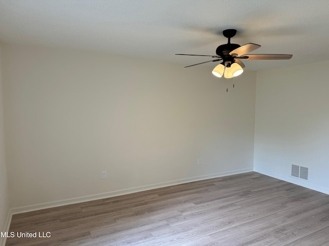 unfurnished room with light hardwood / wood-style floors, a textured ceiling, and ceiling fan