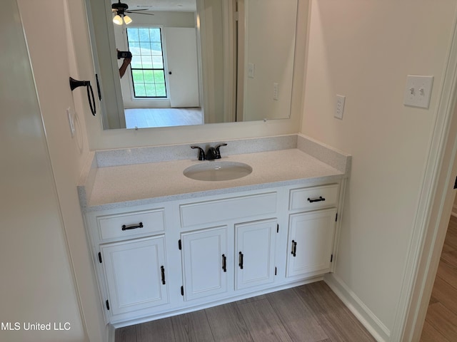 bathroom with vanity, ceiling fan, and hardwood / wood-style floors