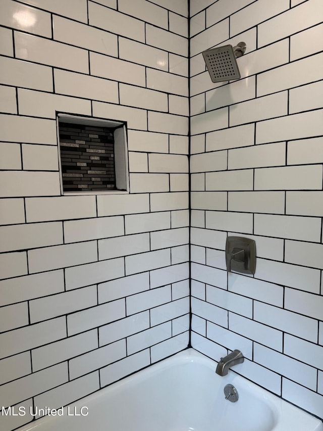 bathroom featuring tiled shower / bath