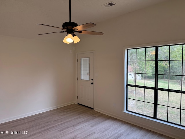 interior space featuring vaulted ceiling, a healthy amount of sunlight, light wood-type flooring, and ceiling fan