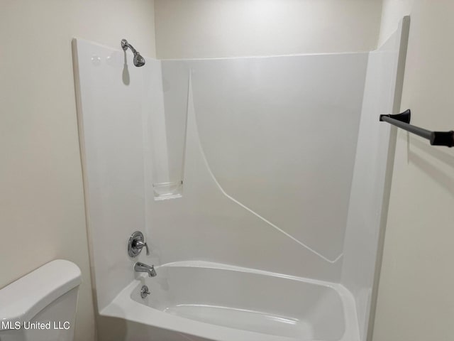 bathroom featuring toilet and shower / bathing tub combination