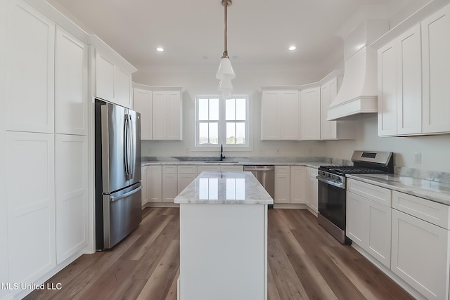 kitchen with appliances with stainless steel finishes, dark hardwood / wood-style floors, custom exhaust hood, and sink