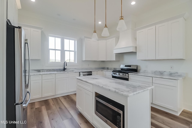 kitchen featuring white cabinetry, stainless steel appliances, and custom exhaust hood