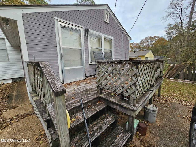 rear view of property featuring a deck