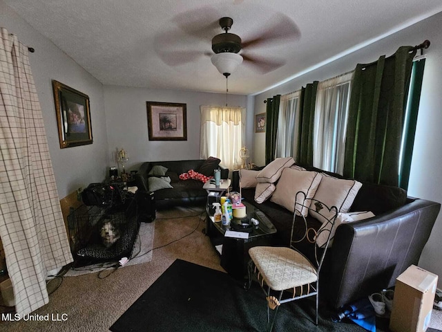 living room featuring a textured ceiling, ceiling fan, and carpet