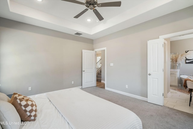 bedroom with baseboards, visible vents, a tray ceiling, recessed lighting, and carpet flooring