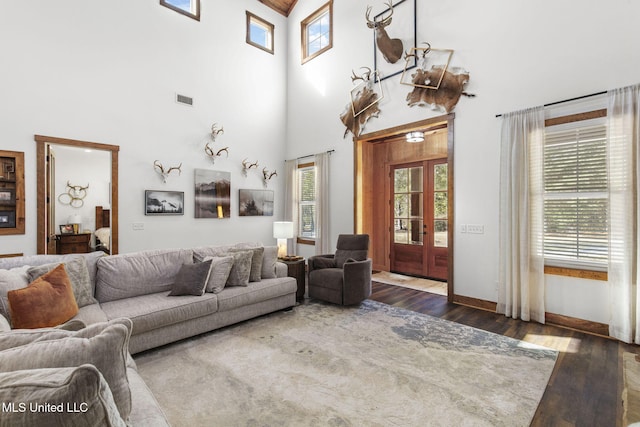 living area with dark wood-type flooring and a wealth of natural light