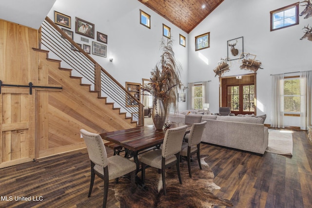 dining space with stairs, wood walls, and a wealth of natural light