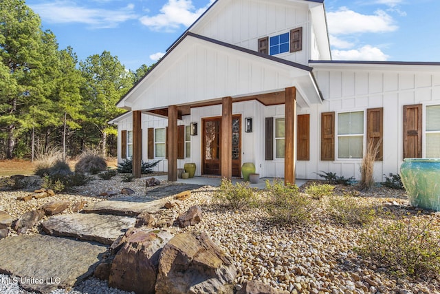 modern inspired farmhouse with board and batten siding and covered porch