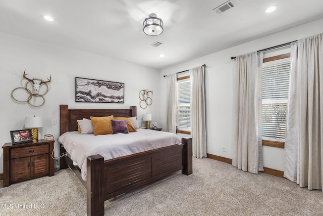 bedroom with light carpet, recessed lighting, visible vents, and baseboards