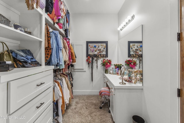 walk in closet featuring light carpet