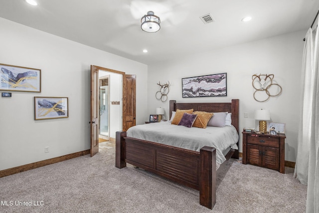 bedroom featuring recessed lighting, visible vents, light carpet, connected bathroom, and baseboards