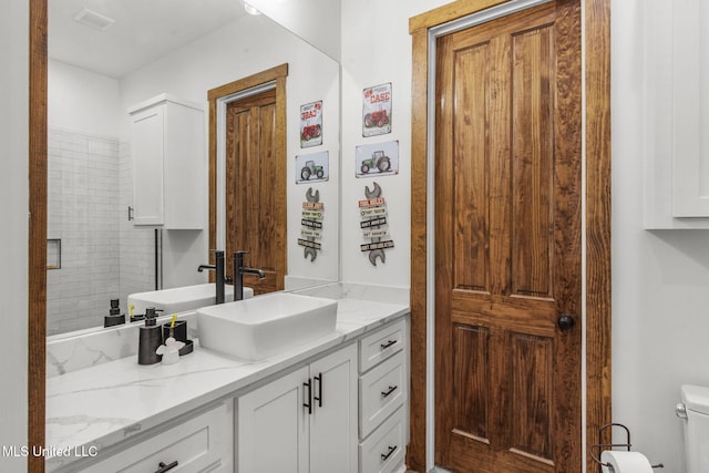 bathroom featuring toilet and vanity