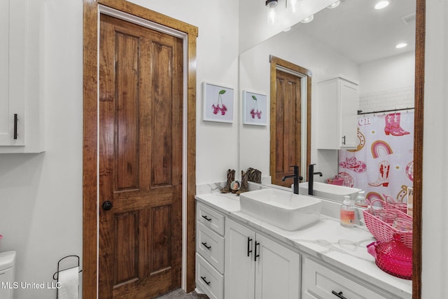 full bathroom with recessed lighting, vanity, and toilet