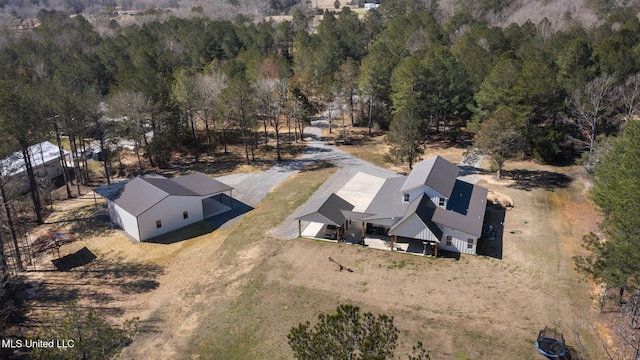 birds eye view of property with a view of trees