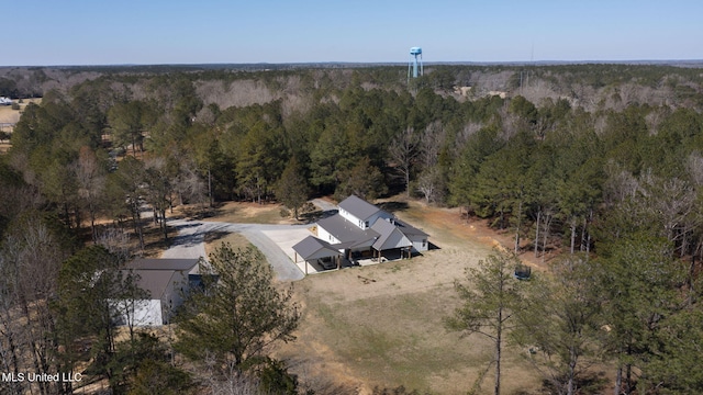 birds eye view of property with a view of trees