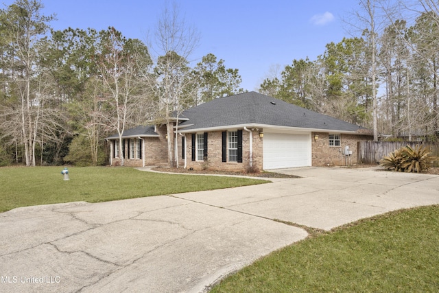 view of front of property featuring brick siding, concrete driveway, a front yard, fence, and a garage