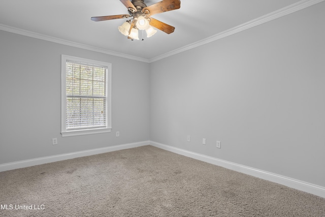 carpeted spare room with crown molding, baseboards, and ceiling fan