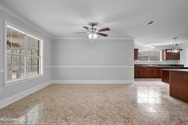 interior space featuring a ceiling fan, visible vents, crown molding, and baseboards