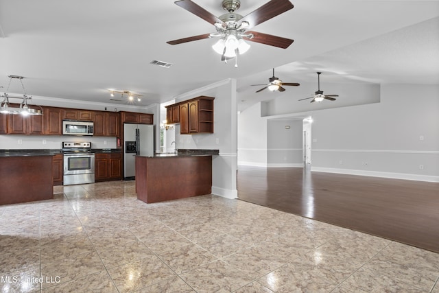 kitchen featuring appliances with stainless steel finishes, dark countertops, open floor plan, and open shelves