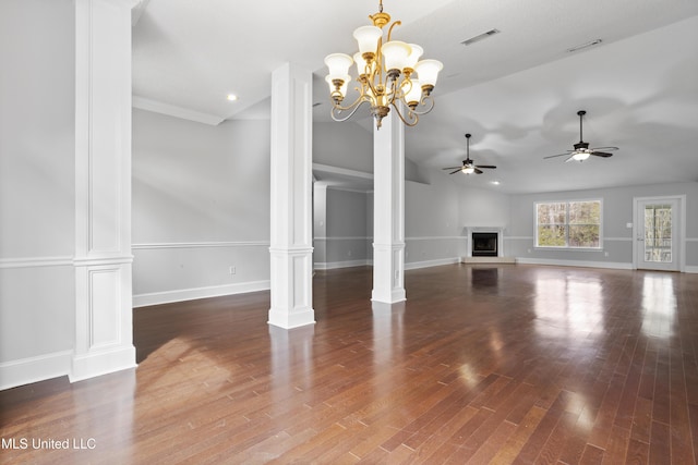 unfurnished living room featuring vaulted ceiling, decorative columns, baseboards, and wood finished floors