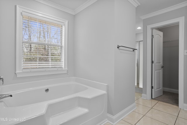 full bathroom featuring baseboards, a bath, tile patterned floors, a stall shower, and crown molding