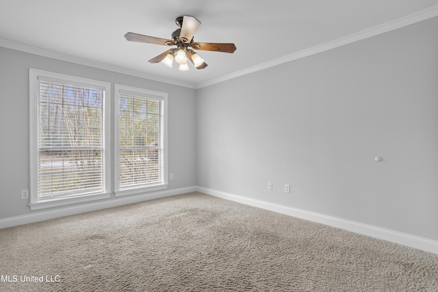 spare room featuring baseboards, carpet floors, a ceiling fan, and crown molding