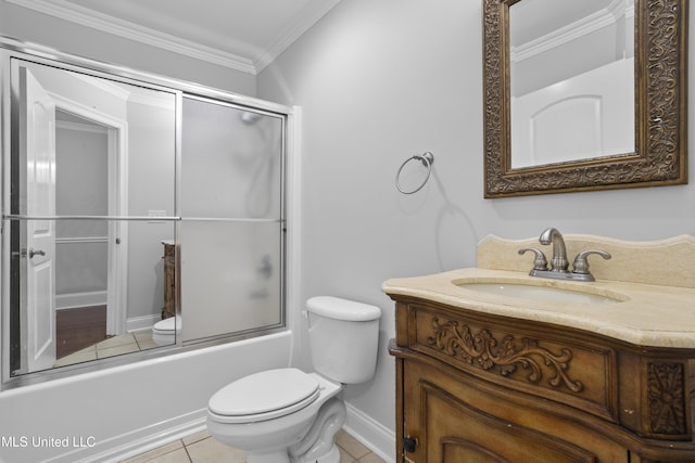 bathroom featuring toilet, vanity, combined bath / shower with glass door, tile patterned floors, and crown molding