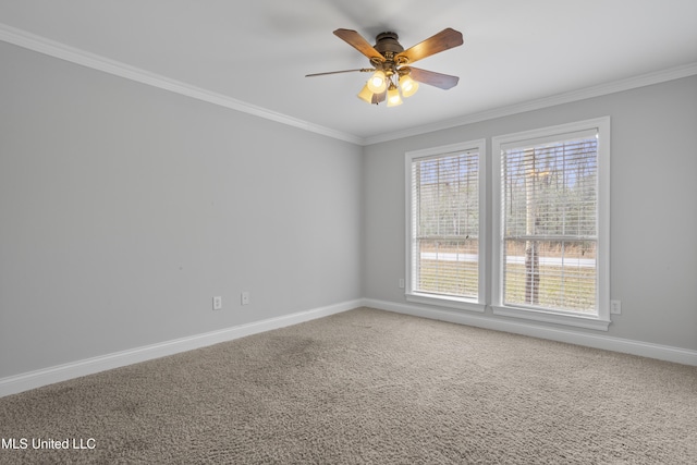 carpeted empty room with baseboards, ornamental molding, and a ceiling fan