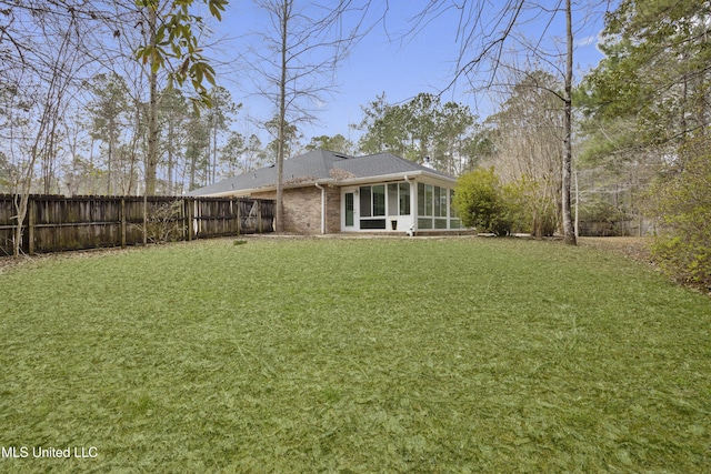 view of yard featuring a sunroom and fence