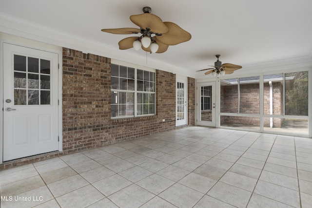 unfurnished sunroom with ceiling fan