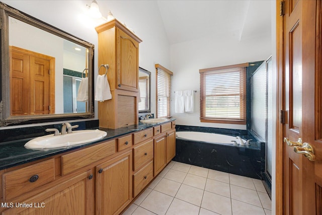 4872 Bobo Pl, Olive Branch, MS 38654 - full bathroom with a garden tub, vaulted ceiling, double vanity, a shower stall, and tile patterned floors