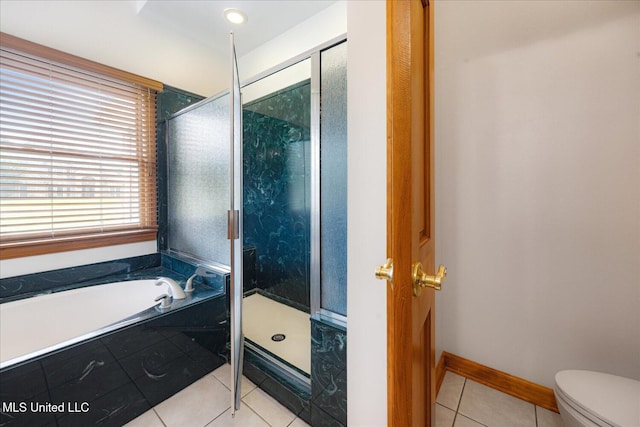 4872 Bobo Pl, Olive Branch, MS 38654 - bathroom with tile patterned floors, a stall shower, a bath, toilet, and baseboards