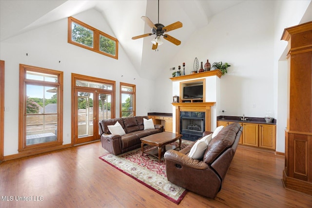 4872 Bobo Pl, Olive Branch, MS 38654 - living room featuring high vaulted ceiling, wood finished floors, a premium fireplace, a ceiling fan, and french doors