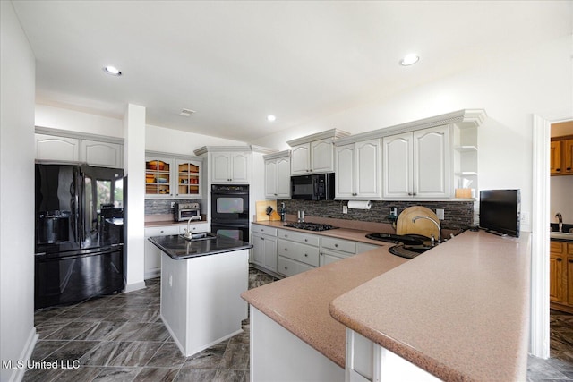 4872 Bobo Pl, Olive Branch, MS 38654 - kitchen with black appliances, a sink, an island with sink, tasteful backsplash, and recessed lighting
