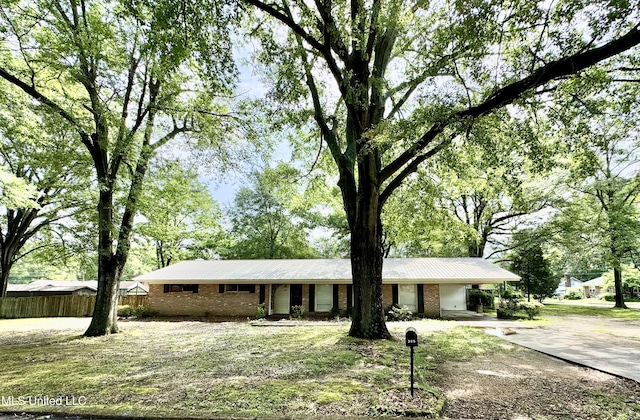 305 N Heard St, Senatobia, MS 38668 - ranch-style home featuring driveway, brick siding, a carport, and a metal roof