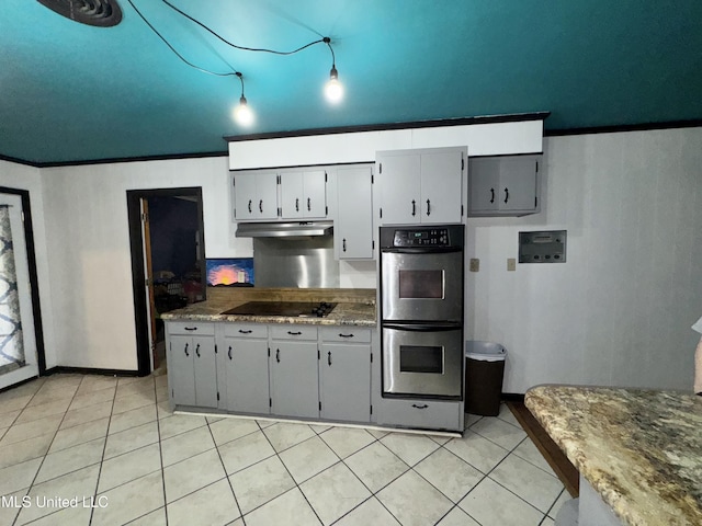 305 N Heard St, Senatobia, MS 38668 - kitchen featuring stainless steel double oven, under cabinet range hood, black electric cooktop, and light tile patterned floors