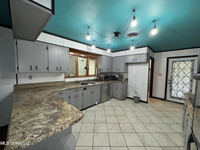 305 N Heard St, Senatobia, MS 38668 - kitchen with stainless steel dishwasher, gray cabinetry, light tile patterned flooring, and dark countertops