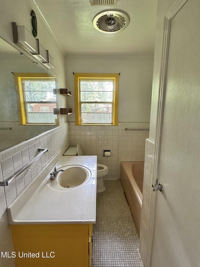 305 N Heard St, Senatobia, MS 38668 - full bath featuring plenty of natural light, tile walls, tile patterned flooring, vanity, and a bath