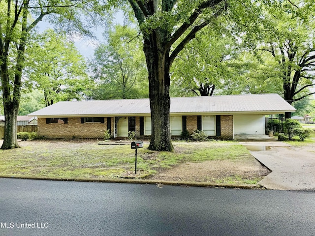 305 N Heard St, Senatobia, MS 38668 - single story home with brick siding, concrete driveway, a carport, and a metal roof