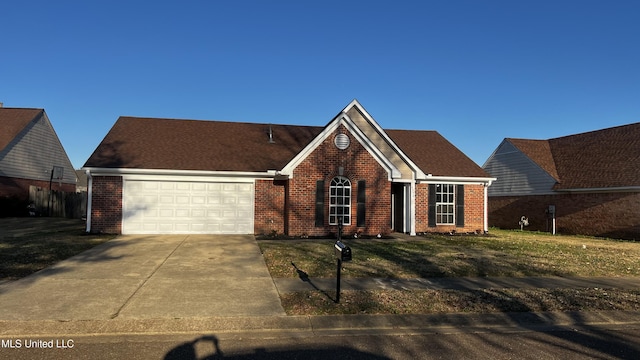 view of front of home featuring a garage and a front lawn