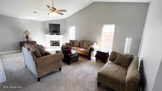 carpeted living room with ceiling fan and vaulted ceiling