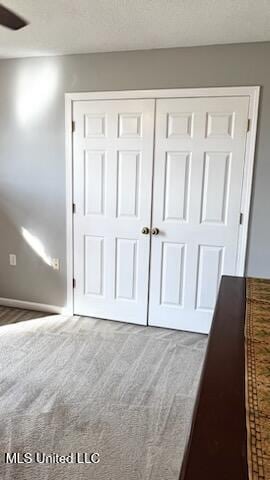 unfurnished bedroom featuring a closet and carpet floors