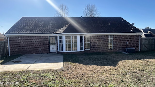 back of property featuring a lawn, a patio area, and central air condition unit