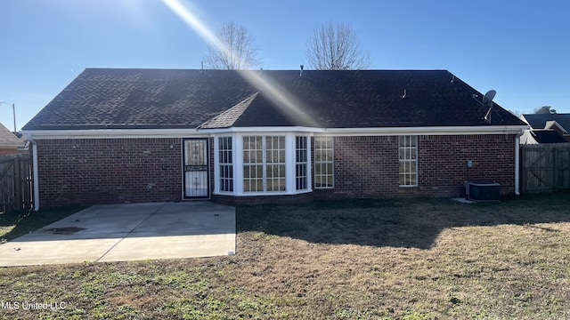 rear view of house featuring a yard and a patio