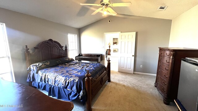 bedroom featuring ceiling fan, light colored carpet, and vaulted ceiling