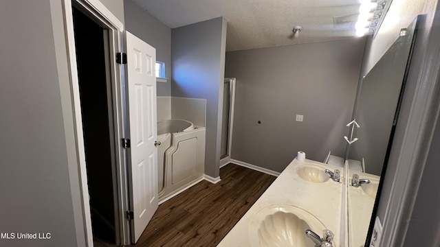 bathroom featuring vanity, independent shower and bath, a textured ceiling, and hardwood / wood-style flooring